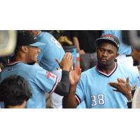 Hickory Crawdads 1B Tyreque Reed receives high fives in the dugout