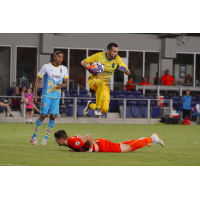 Las Vegas Lights FC goalkeeper Ricardo Ferrino leaps over a fallen opponent