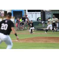 Texarkana Twins complete a throw to first for an out