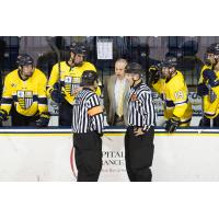 Mark Dennehy consults with the officials while with Merrimack College